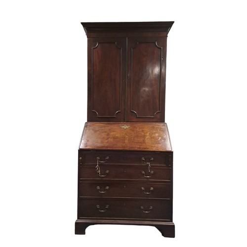 315 - A GEORGIAN MAHOGANY BUREAU CABINET the moulded cornice above a pair of panel doors containing adjust... 