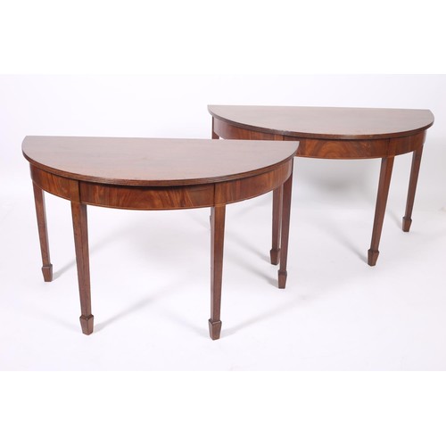 386 - A PAIR OF GEORGIAN MAHOGANY SIDE TABLES each of demilune outline with reeded rim above a moulded apr... 