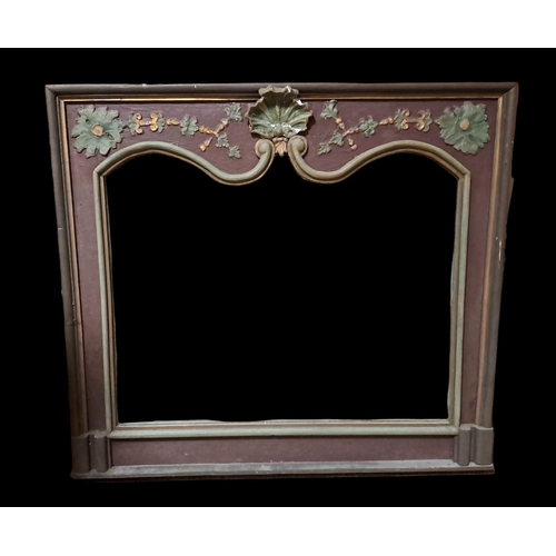 412 - A CONTINENTAL PINE AND PAINTED OVERMANTEL MIRROR the shaped plate within a moulded slip with shell, ... 