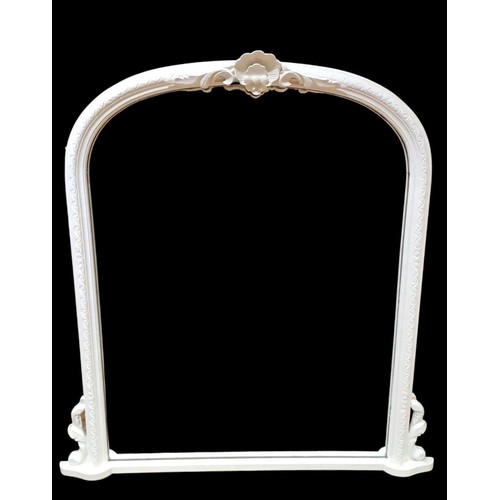 298 - A VICTORIAN STYLE WHITE PAINTED OVERMANTEL MIRROR the rectangular arched plate within a scroll decor... 