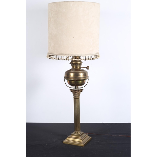 104 - A VINTAGE BRASS CORINTHIAN COLUMN OIL LAMP, now converted, the reeded column above a square stepped ... 