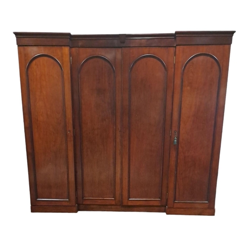 164 - A FINE 19TH CENTURY MAHOGANY THREE DOOR BREAKFRONT WARDROBE of inverted breakfront outline the mould... 