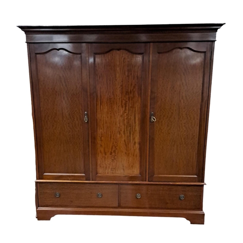 166 - AN EDWARDIAN MAHOGANY AND SATINWOOD INLAID THREE DOOR WARDROBE the moulded cornice above three panel... 