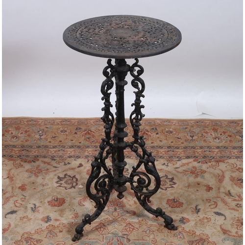 178 - A CAST IRON TABLE of circular outline the shaped pierced top with pierced C-scroll supports on scrol... 