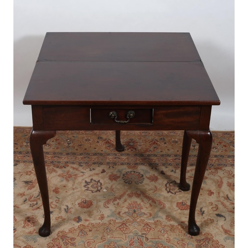 179 - A GEORGIAN MAHOGANY FOLDOVER SUPPER TABLE the rectangular hinged top with frieze drawer on cabriole ... 