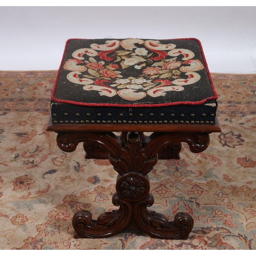 181 - A 19TH CENTURY CARVED MAHOGANY STOOL the rectangular needlework upholstered seat on foliate carved s... 