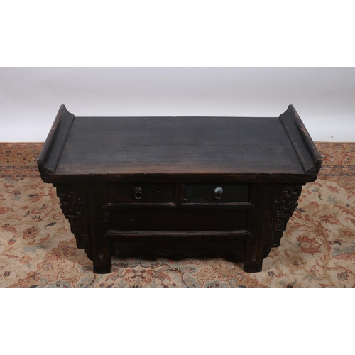 185 - AN ORIENTAL STAINED WOOD COFFEE TABLE of rectangular outline the shaped top with moulded ends with t... 