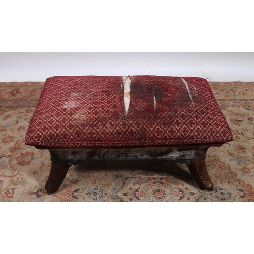 186 - A REGENCY MAHOGANY AND UPHOLSTERED STOOL the rectangular seat with cavetto frieze on splayed legs wi... 