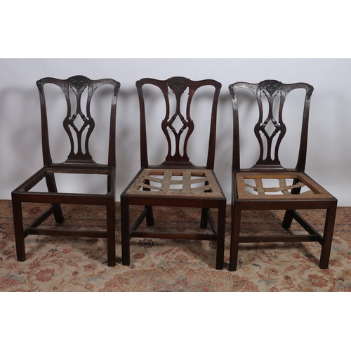 205 - A SET OF FOUR GEORGIAN MAHOGANY SIDE CHAIRS each with a shaped top rail with pierced carved splats o... 