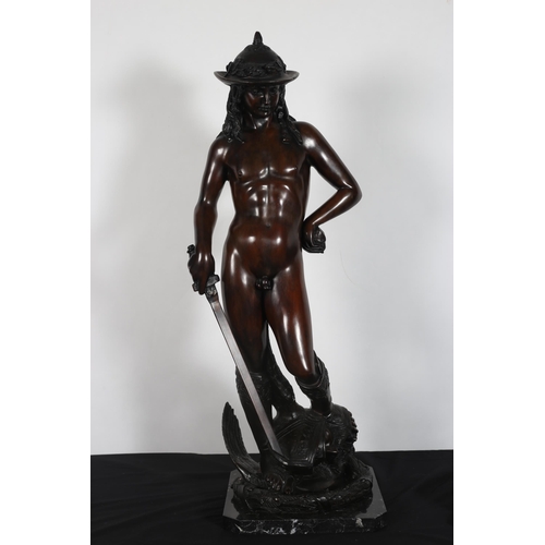 213 - after DONATELLO 
A bronze figure modelled as David shown standing on a naturalistic base with black ... 