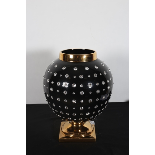 215 - A CRISTAUX DE SWAROVSKI VASE of bulbous form the black and gilt ground inset with faceted stones abo... 