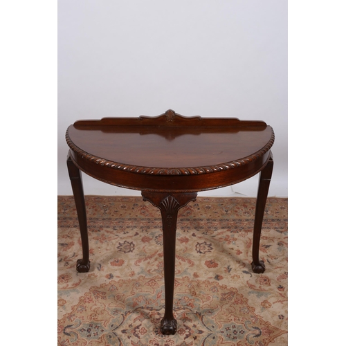 224 - A VINTAGE CHIPPENDALE STYLE MAHOGANY SIDE TABLE of demi lune outline the shaped top with gadrooned r... 