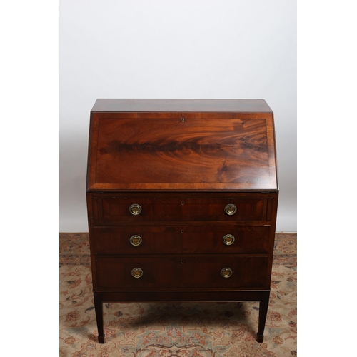 256 - A GEORGIAN STYLE MAHOGANY CROSSBANDED BUREAU the hinged writing slope with tooled leather inset cont... 