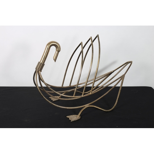 274 - A MAISON JENSEN SWAN SHAPED BRASS MAGAZINE RACK 
40cm (h) x 64cm (w)