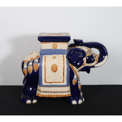 304 - A CHINOISERIE CERAMIC JARDINIERE modelled as an elephant the white and cobalt blue ground moulded in... 