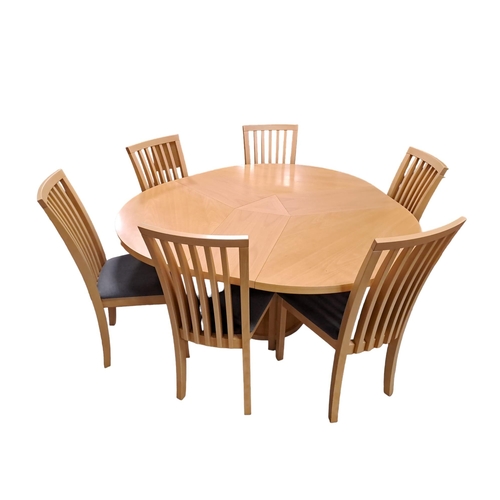 317 - A DESIGNER BEECHWOOD SEVEN PIECE BREAKFAST SUITE comprising six dining chairs each with a curved top... 