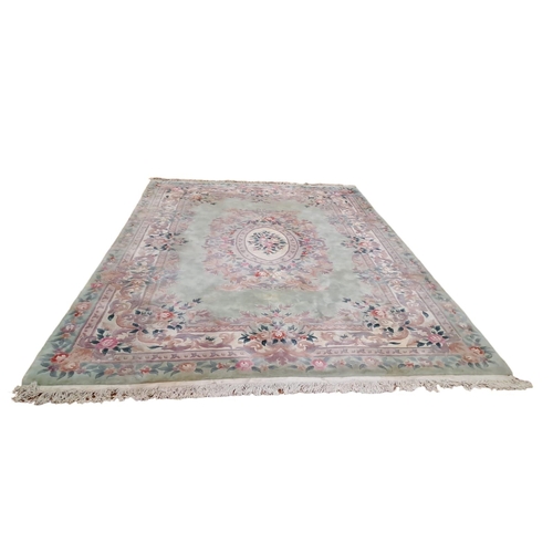 320 - A CHINESE WOOL RUG the turquoise, light pink and beige ground with central panel filled with stylise... 