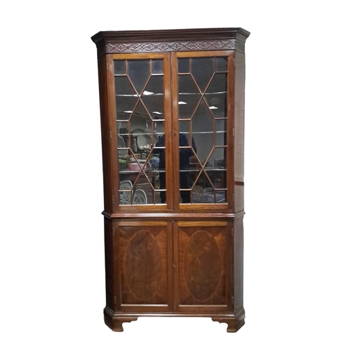 330 - A HEPPLEWHITE STYLE MAHOGANY CORNER CABINET the dentil moulded cornice above a pair of astragal glaz... 