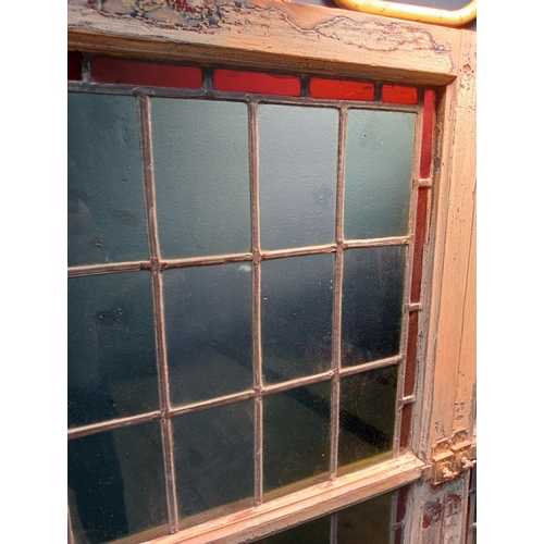 346 - A PAIR OF VINTAGE PINE LEAD GLASS AND COLOURED GLASS WINDOWS each of rectangular form with brass hin... 