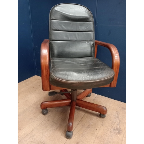 357 - A VINTAGE TEAK AND HIDE UPHOLSTERED SWIVEL OFFICE CHAIR the rectangular arched upholstered back and ... 