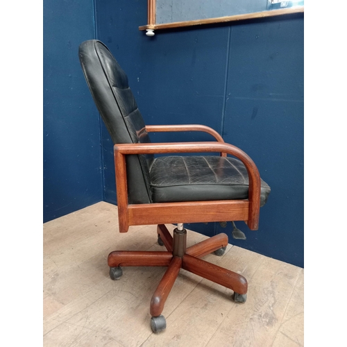 357 - A VINTAGE TEAK AND HIDE UPHOLSTERED SWIVEL OFFICE CHAIR the rectangular arched upholstered back and ... 