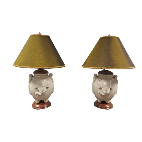 360 - A PAIR OF GLAZED CHINA TABLE LAMPS each modelled as an elephant shown standing on a hardwood base wi... 