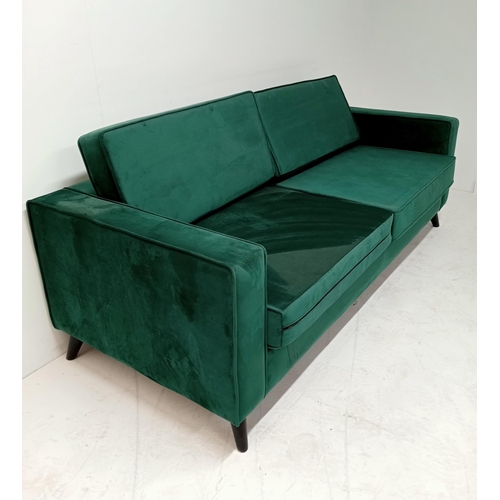 363 - A GREEN BRUSHED VELVET AND EBONISED SETTEE of rectangular outline with loose cushions on cylindrical... 