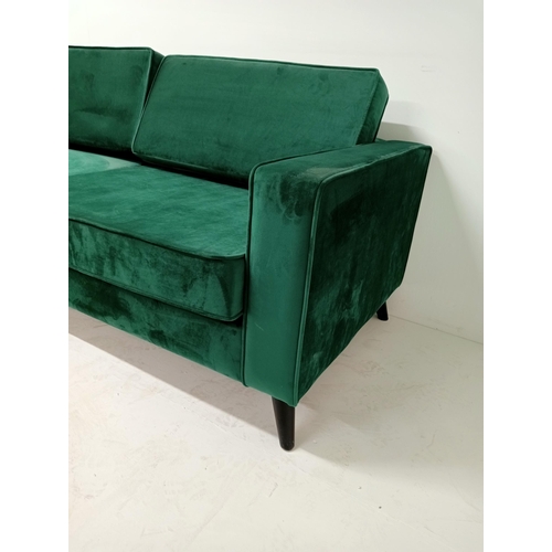 363 - A GREEN BRUSHED VELVET AND EBONISED SETTEE of rectangular outline with loose cushions on cylindrical... 