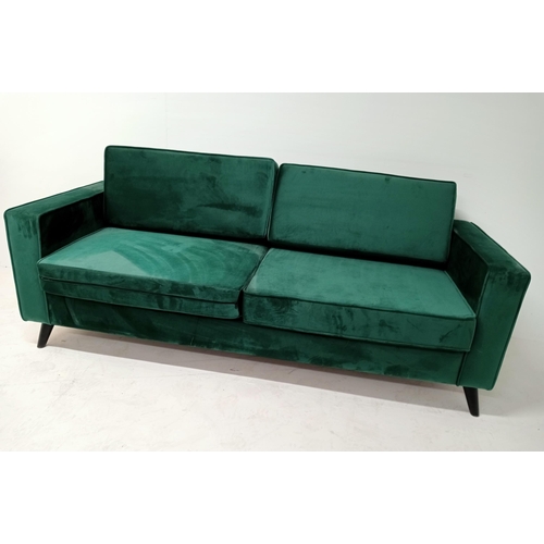 363 - A GREEN BRUSHED VELVET AND EBONISED SETTEE of rectangular outline with loose cushions on cylindrical... 