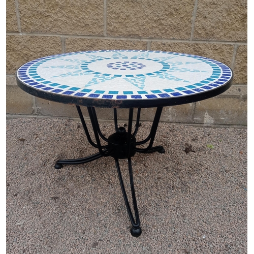 367 - A WROUGHT IRON AND MOSAIC PATIO TABLE the circular moulded top raised on splayed legs with spherical... 