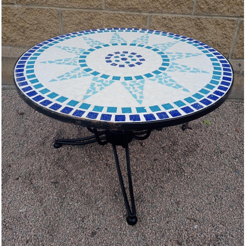 367 - A WROUGHT IRON AND MOSAIC PATIO TABLE the circular moulded top raised on splayed legs with spherical... 