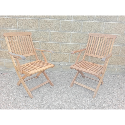 373 - A PAIR OF TEAK FOLDING DECK CHAIRS with slatted back and seat and shaped arms on X-shaped folding ba... 