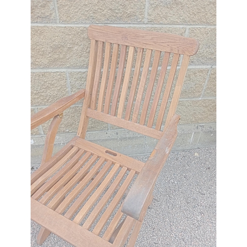 373 - A PAIR OF TEAK FOLDING DECK CHAIRS with slatted back and seat and shaped arms on X-shaped folding ba... 