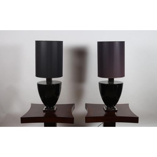 402 - A PAIR OF BLACK AND GILT GLAZED TABLE LAMPS each of ovoid tapering form raised on a square stepped b... 