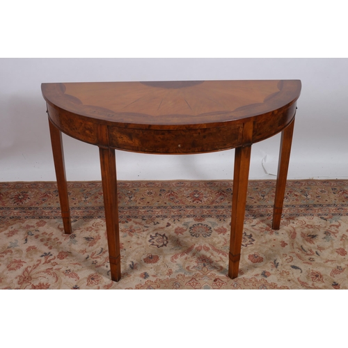 404 - A SHERATON STYLE WALNUT AND SATINWOOD SIDE TABLE of demi lune outline the shaped top above a moulded... 