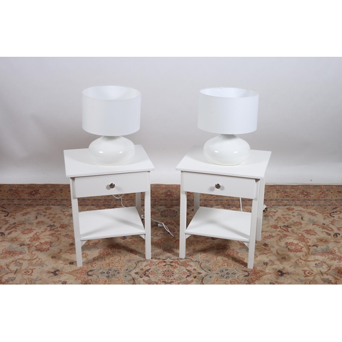 413 - A PAIR OF WHITE PAINTED OCCASIONAL TABLES each of rectangular outline the shaped tops with frieze dr... 