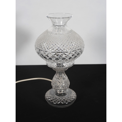 423 - A WATERFORD HOBNAIL CUT TABLE LAMP the bulbous shade above a knopped column on a circular spreading ... 