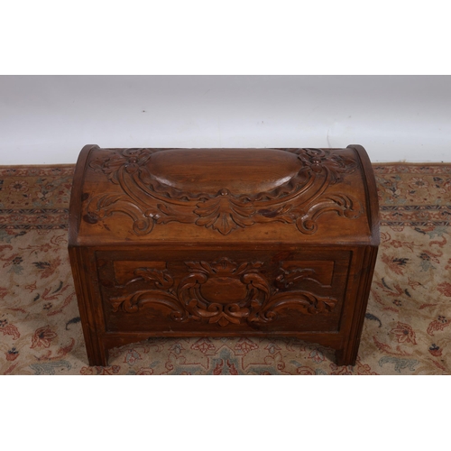 61 - A CONTINENTAL CARVED PINE TRUNK of rectangular dome form the hinged lid with foliate and scroll carv... 