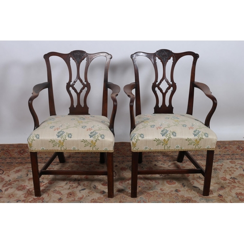 83 - A PAIR OF GEORGIAN MAHOGANY CHIPPENDALE ELBOW CHAIRS each with a carved arched top rail with pierced... 