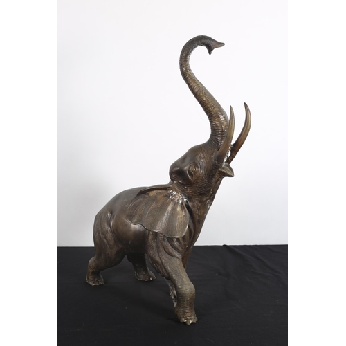 92 - A BRONZE FIGURE modelled as an elephant shown standing with its trunk raised 
72cm (h) x 71cm (w)