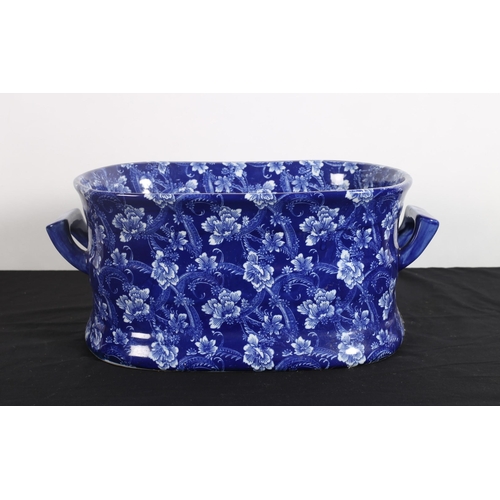 96 - AN IRONSTONE BLUE AND WHITE JARDINIERE of oval outline with carrying handles decorated overall with ... 