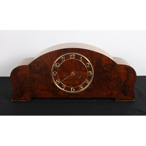 99 - A VINTAGE WALNUT CASED MANTEL CLOCK of rectangular arched outline on moulded legs 
24cm (h) x 53cm (... 