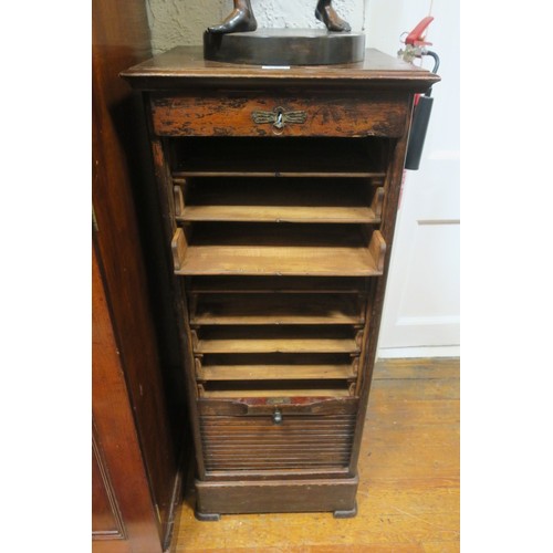 168 - A VINTAGE OAK FILING UNIT of rectangular outline the shaped top above a frieze drawer with tambour s... 