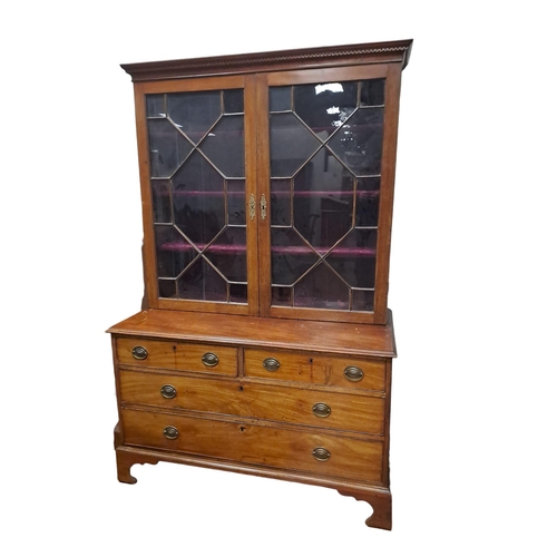 20 - A GEORGIAN MAHOGANY BOOKCASE ON CHEST the dentil moulded cornice above a pair of astragal glazed doo... 