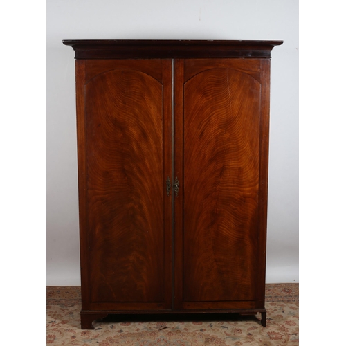 22 - A 19TH CENTURY MAHOGANY WARDROBE the moulded cornice above a pair of panelled doors containing hangi... 