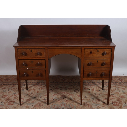 23 - A GEORGIAN MAHOGANY SIDEBOARD of rectangular outline the shaped top with moulded three quarter galle... 