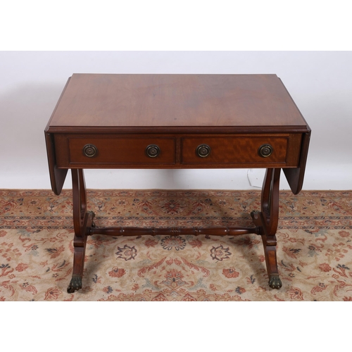 35 - A GEORGIAN DESIGN MAHOGANY SOFA TABLE of rectangular outline the shaped top with hinged leaves above... 