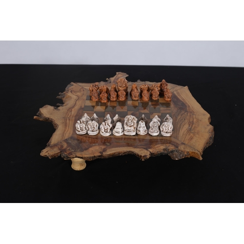 91 - A BURR WALNUT INLAID CHESS BOARD of irregular outline with frieze drawer complete with thirty two ch... 