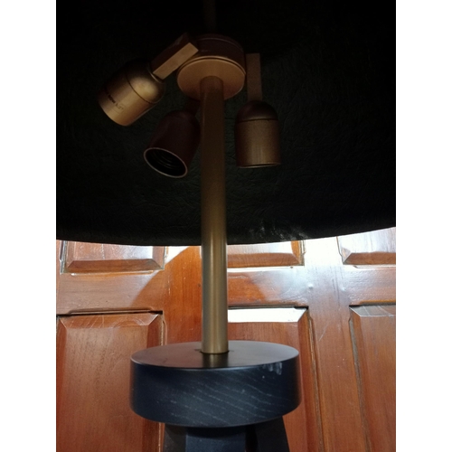 489 - A PAIR OF EBONISED AND BRASS FLOOR STANDARD LAMPS each on a tripod support with tapering legs and br... 