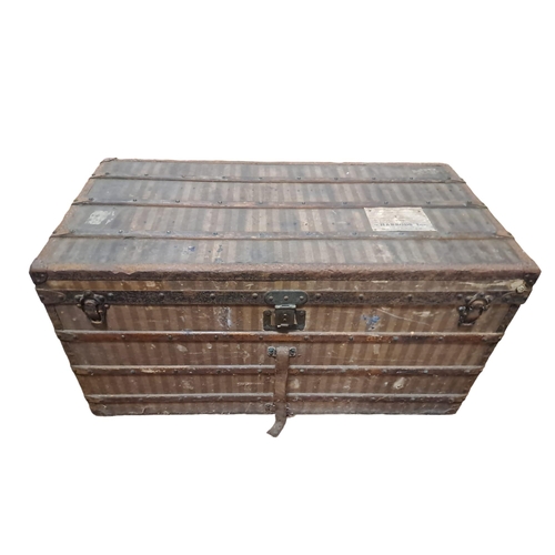 100 - A LOUIS VUITTON MALLE CABINE covered in striped canvas bound in wood and metal with brass studs flan... 